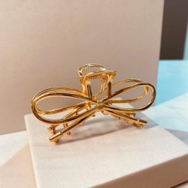 PRENDEDOR LAÇO OURO