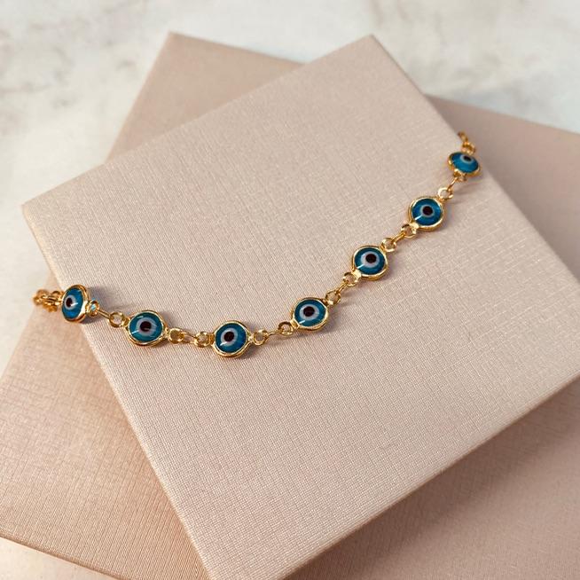 PL OURO OLHO GREGO AZUL CLARO